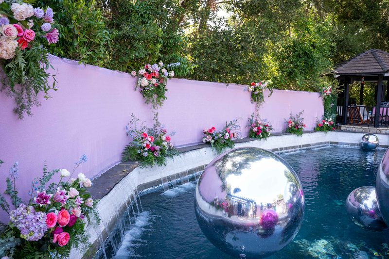 Florals climbing a pink garden wall