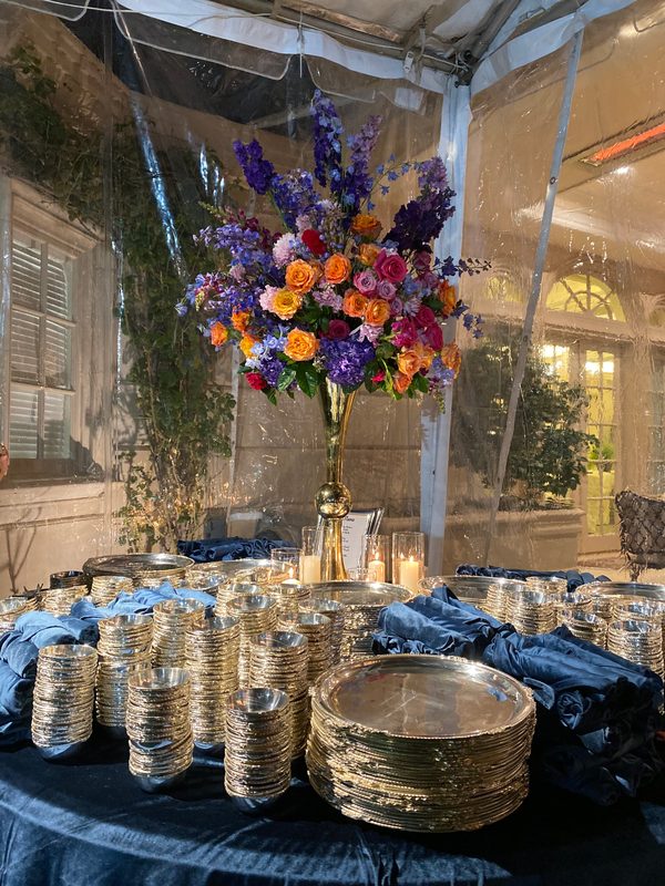 Elevated centerpiece over gold chargers