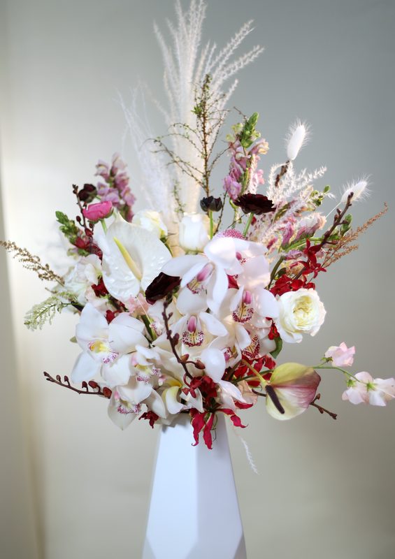 Orchids and pampas, white vase